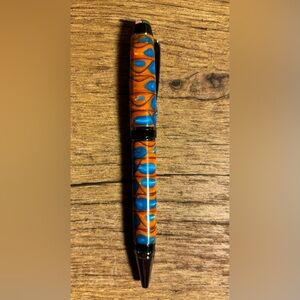 Hand turned acrylic ink pen. Smooth writing black ink. Black/silver accents.